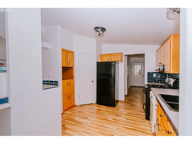 a kitchen with granite countertop a sink and cabinets