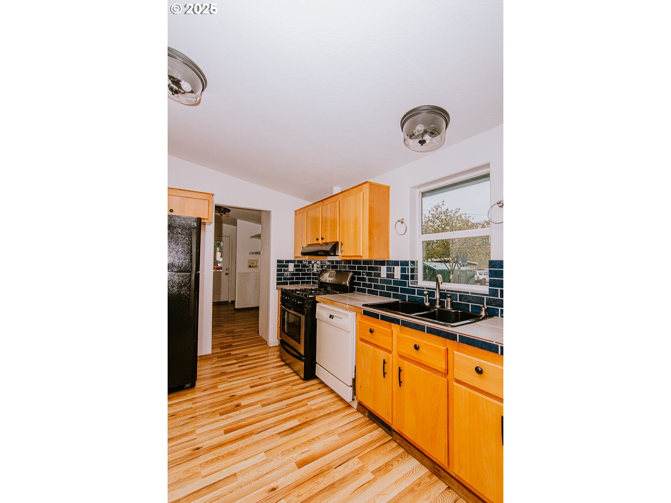 88247 Ellmaker Road Veneta, OR 97487 - Photo 24 of 47 a kitchen with granite countertop a sink and cabinets