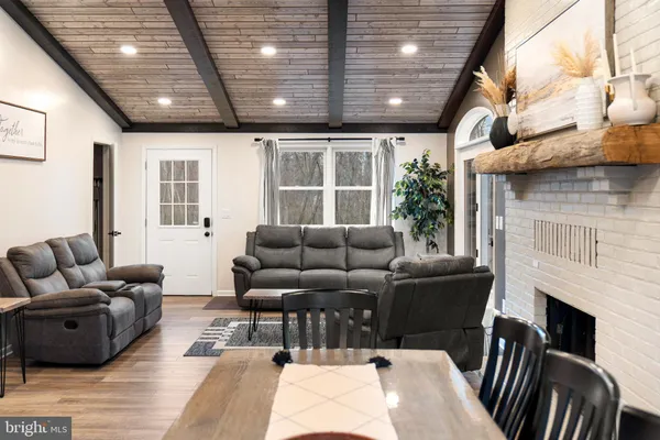 a kitchen with kitchen island white cabinets and stainless steel appliances