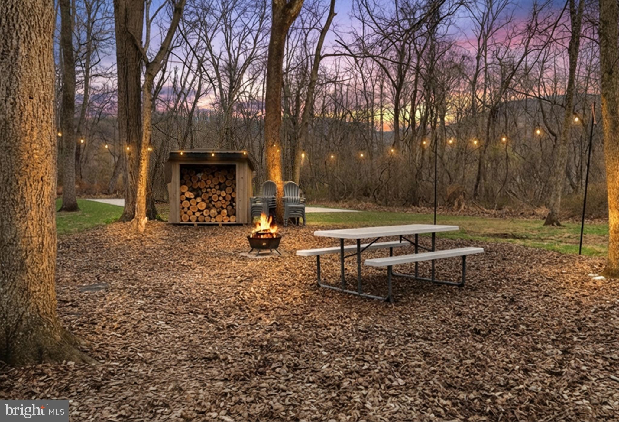 158 Juniata Division Road Lewistown, PA 17044 - Photo 2 of 70 a view of a backyard with lawn chairs and a fire pit