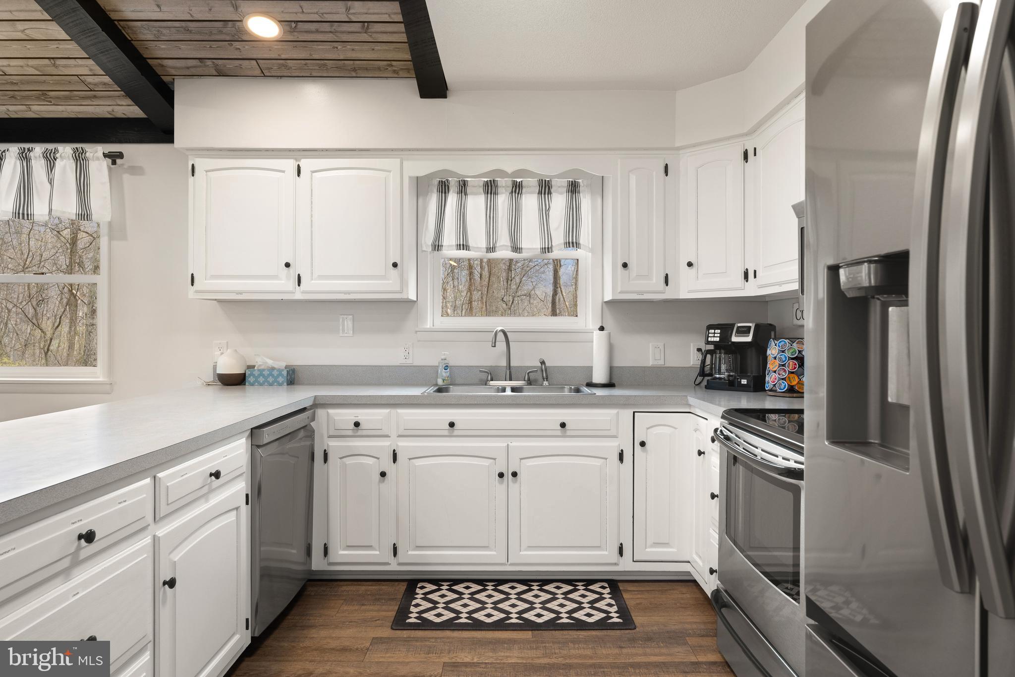 158 Juniata Division Road Lewistown, PA 17044 - Photo 26 of 70 a kitchen with white cabinets and white appliances