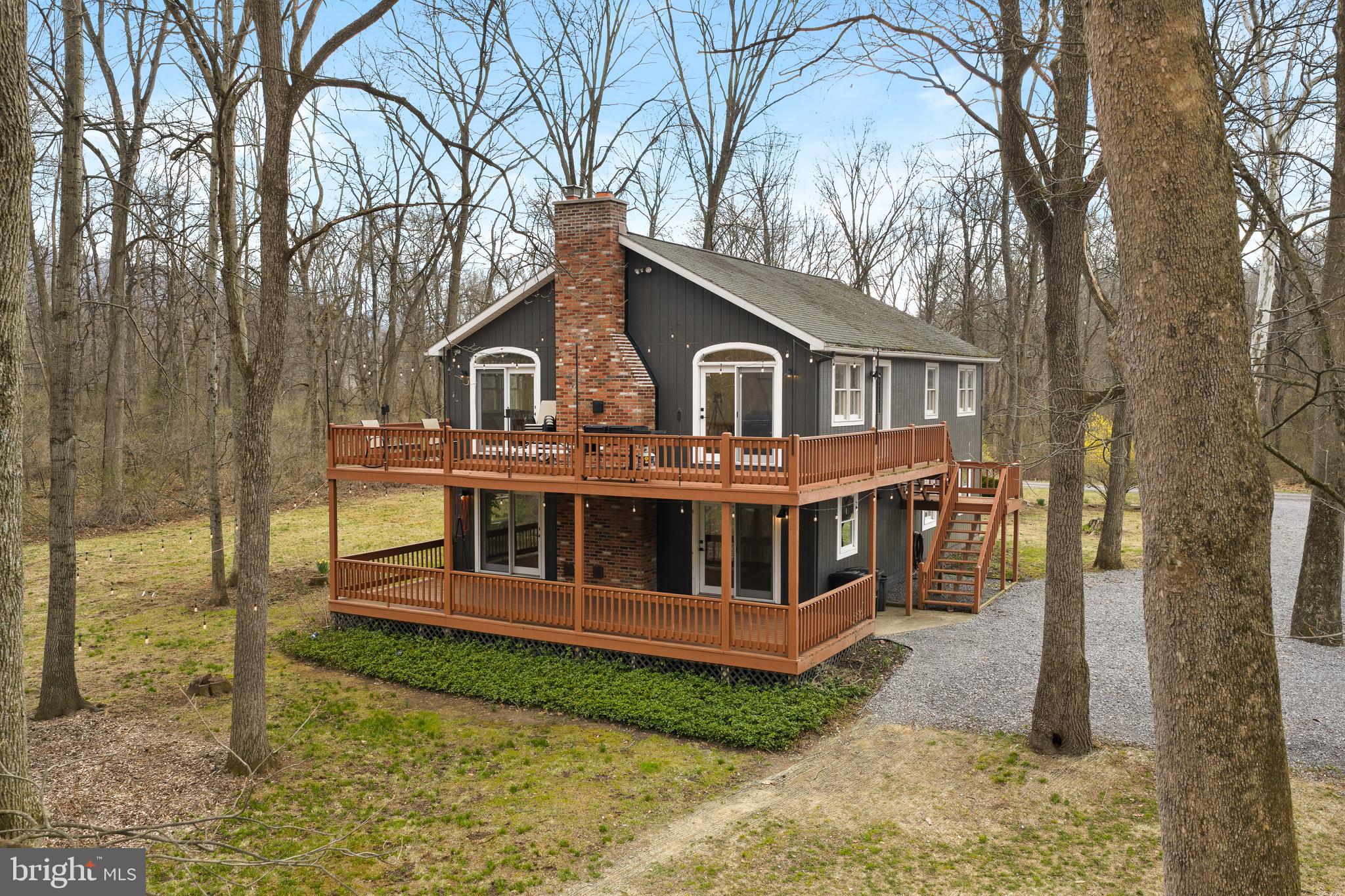 158 Juniata Division Road Lewistown, PA 17044 - Photo 62 of 70 a view of a house with a wooden deck and a yard