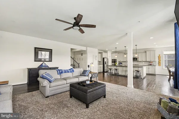 a kitchen with granite countertop white cabinets and stainless steel appliances