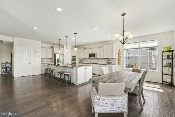 a living room with furniture and painting on the wall