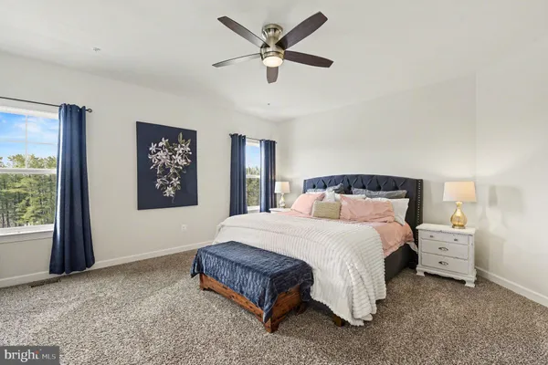 a bedroom with a large bed and a chandelier