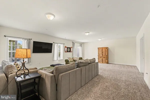 a view of a white house with a big yard and large trees