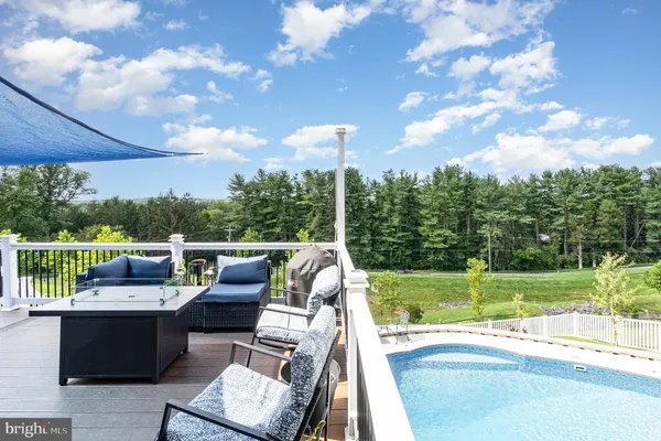 a view of a house with a yard and deck