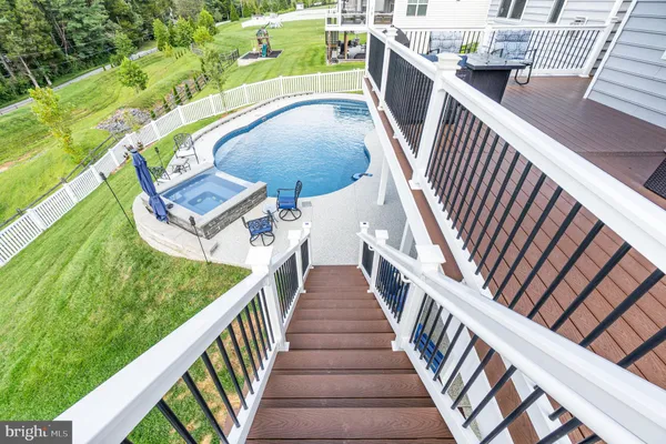 a view of a swimming pool with lounge chair