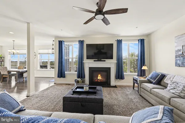 a dining room with wooden floor a chandelier a wooden table and chairs