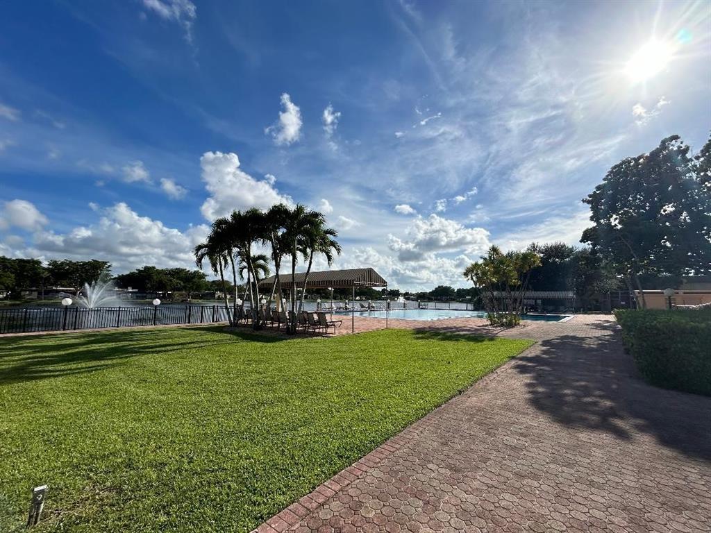 100 Berkley Road, Unit 105 Hollywood, FL 33024 - Photo 14 of 18 a view of a swimming pool with a yard