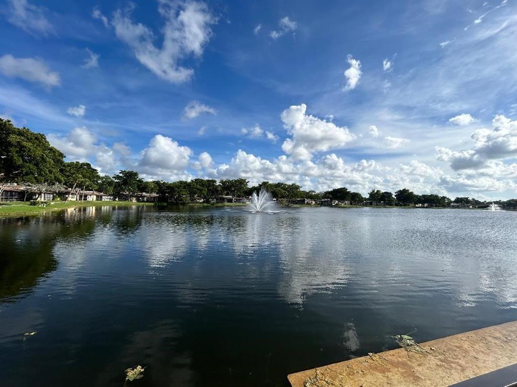 100 Berkley Road, Unit 105 Hollywood, FL 33024 - Photo 16 of 18 a view of a lake in between two of people