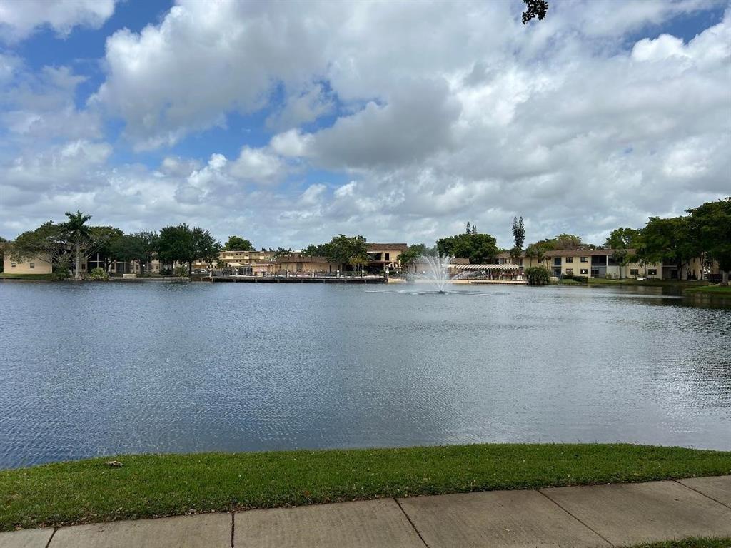 100 Berkley Road, Unit 105 Hollywood, FL 33024 - Photo 17 of 18 a view of a lake with houses in the background