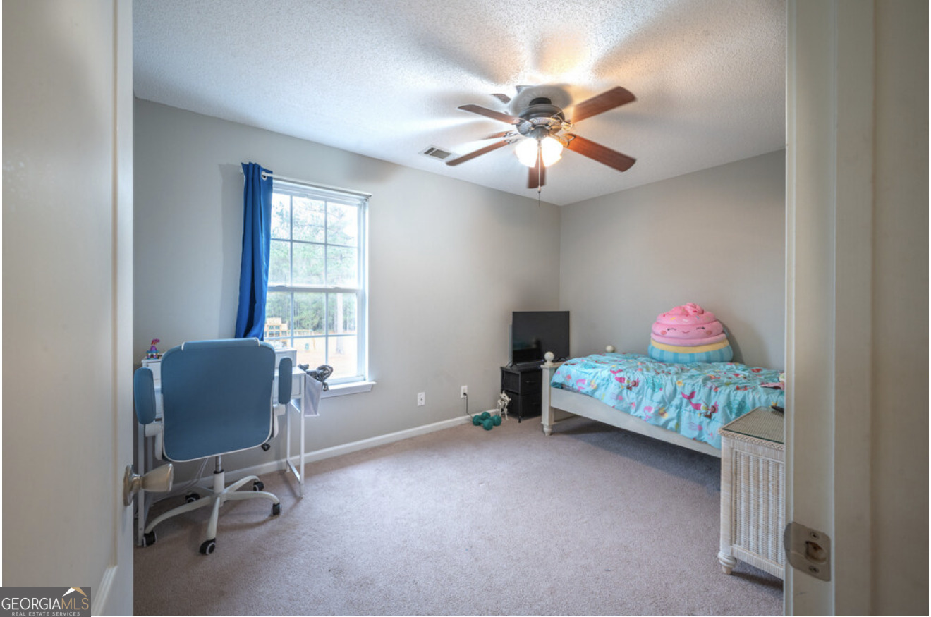 59 Laurel Way Ludowici, GA 31316 - Photo 20 of 21 a bedroom with a bed and a chandelier