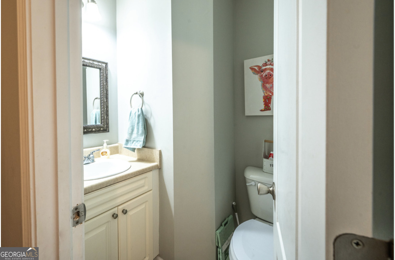 59 Laurel Way Ludowici, GA 31316 - Photo 21 of 21 a bathroom with a granite countertop toilet sink and mirror