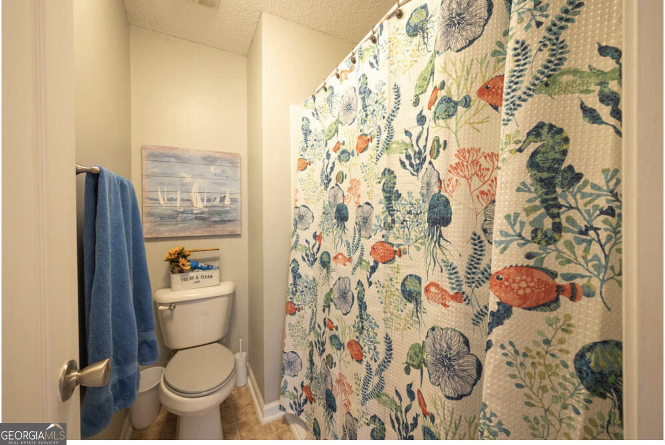 59 Laurel Way Ludowici, GA 31316 - Photo 3 of 21 a bathroom with a toilet and a shower curtain