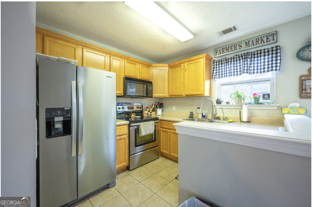 59 Laurel Way Ludowici, GA 31316 - Photo 8 of 21 a kitchen with a sink cabinets stainless steel appliances and a window