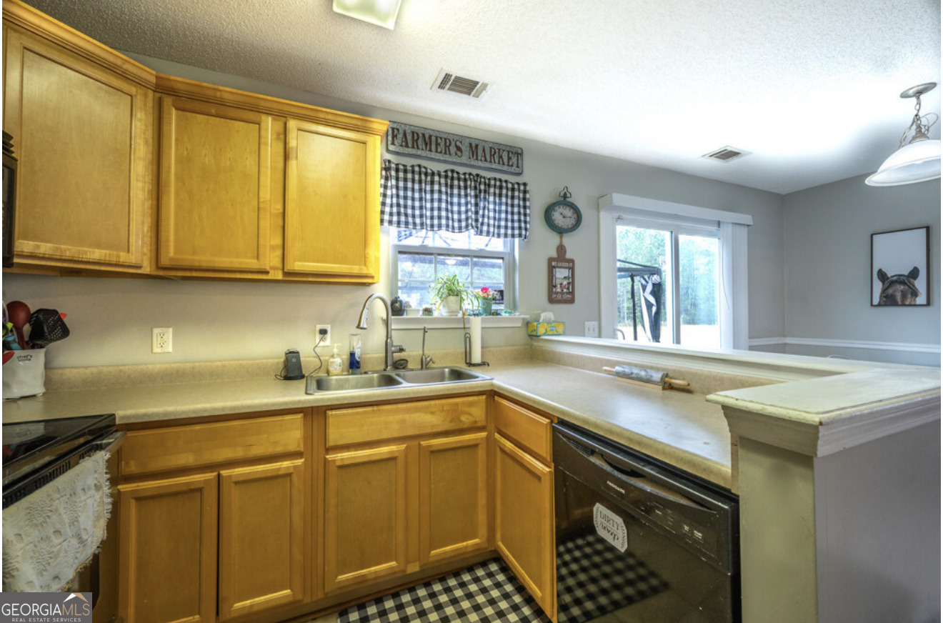 59 Laurel Way Ludowici, GA 31316 - Photo 9 of 21 a kitchen with stainless steel appliances granite countertop a sink stove and cabinets