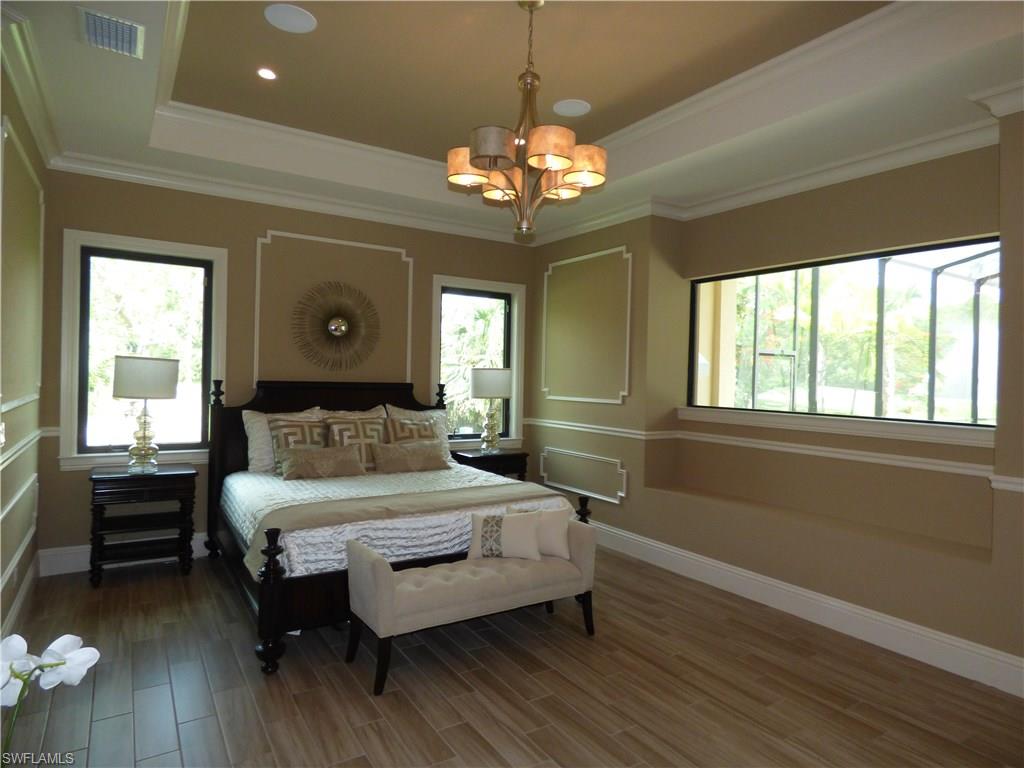 6376 Burnham Road Naples, FL 34119 - Photo 13 of 23 a bedroom with a bed mirror and a window