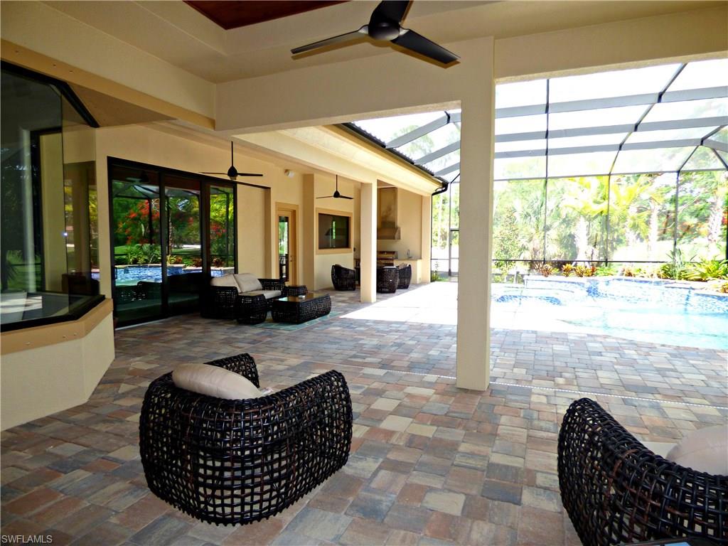 6376 Burnham Road Naples, FL 34119 - Photo 15 of 23 a living room with furniture floor to ceiling window and a table