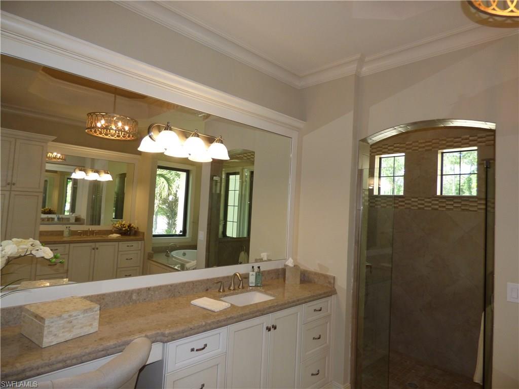6376 Burnham Road Naples, FL 34119 - Photo 17 of 23 a bathroom with a granite countertop sink and a mirror