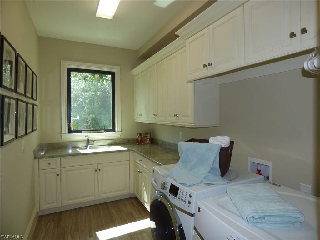 6376 Burnham Road Naples, FL 34119 - Photo 19 of 23 a kitchen with a sink cabinets and window