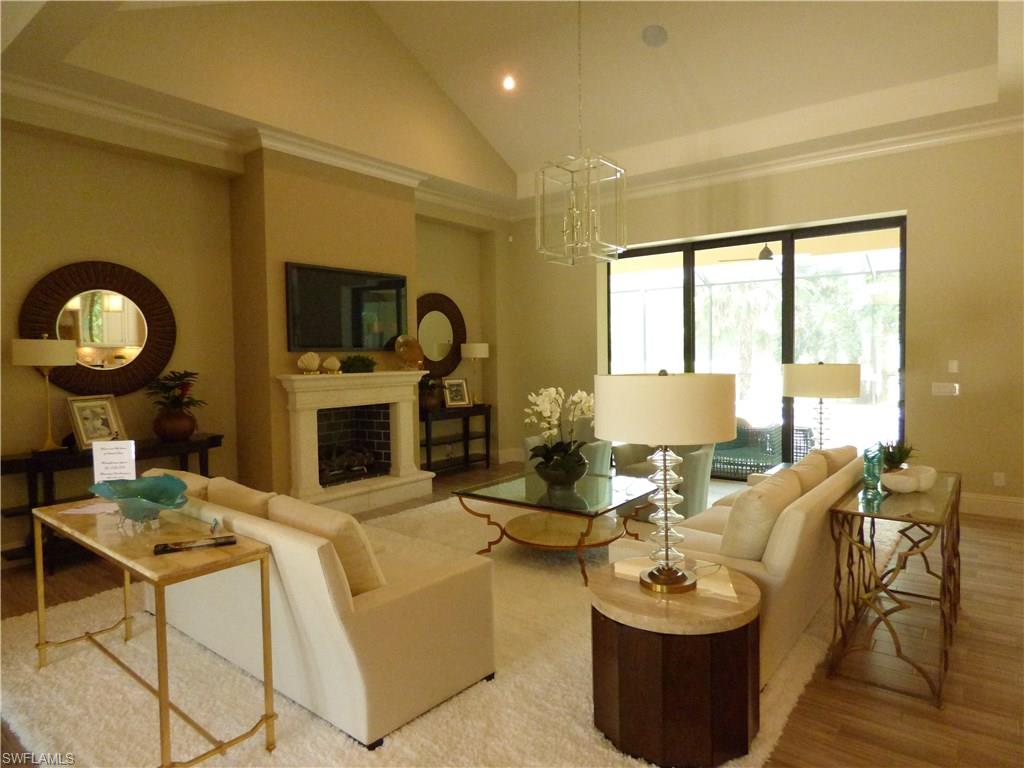 6376 Burnham Road Naples, FL 34119 - Photo 3 of 23 a living room with fireplace furniture and a large window
