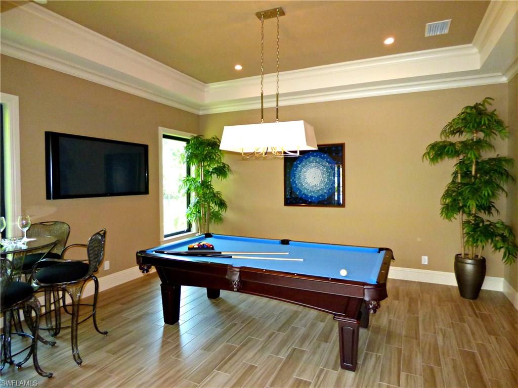 6376 Burnham Road Naples, FL 34119 - Photo 5 of 23 a living room with furniture and a flat screen tv