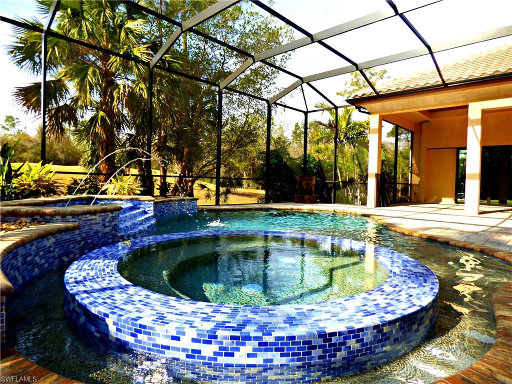6376 Burnham Road Naples, FL 34119 - Photo 7 of 23 a view of a swimming pool with a patio