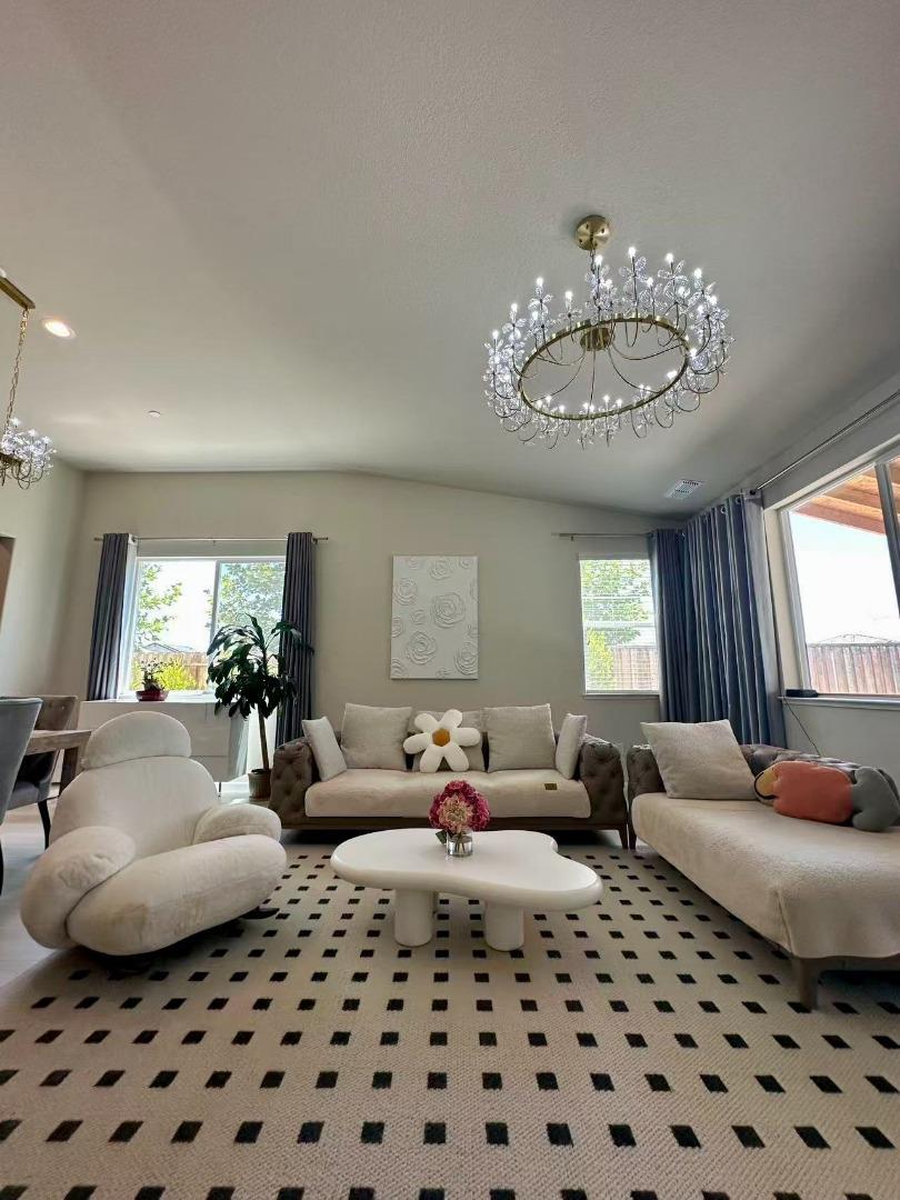 4341 Trailblazer Way Modesto, CA 95356 - Photo 12 of 27 a living room with furniture or couch and a chandelier