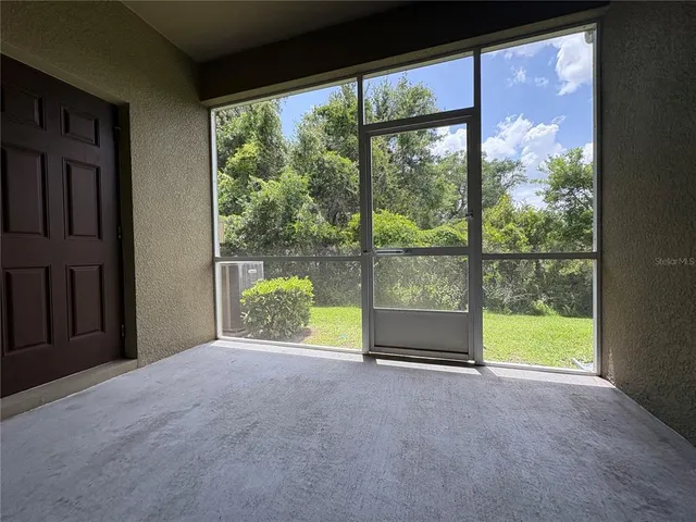 a view of an empty room with a large window