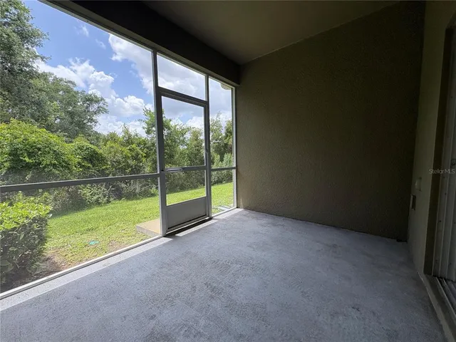 a view of a room with a floor to ceiling window next to a yard