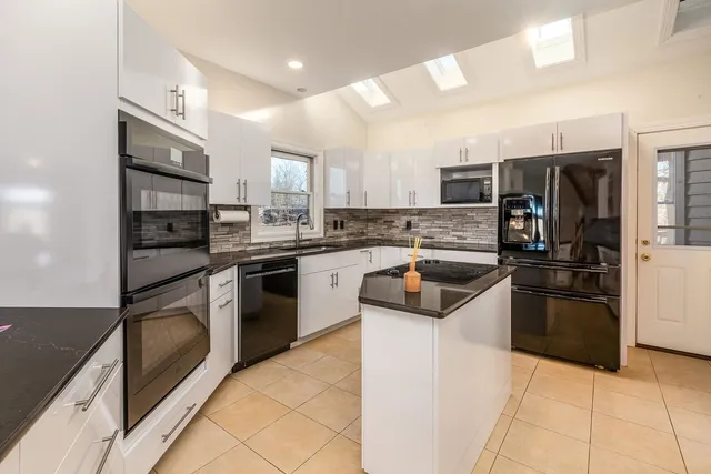 a dining room with furniture a floor to ceiling window and outdoor view