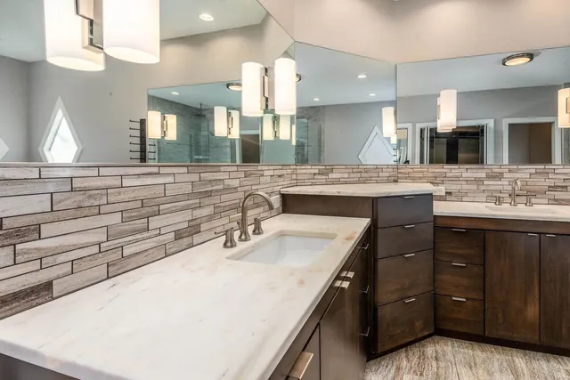 a bathroom with a glass shower door and a mirror