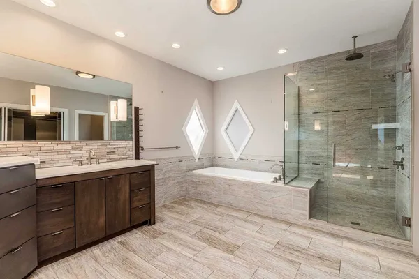 a bathroom with a glass shower door and a mirror