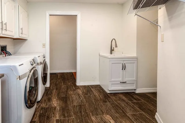 a utility room with sink dryer and washer