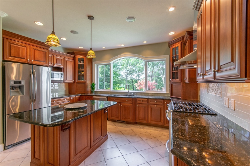 7 Western View Road Holyoke, MA 01040 - Photo 14 of 42 a kitchen with stainless steel appliances granite countertop a sink stove and refrigerator