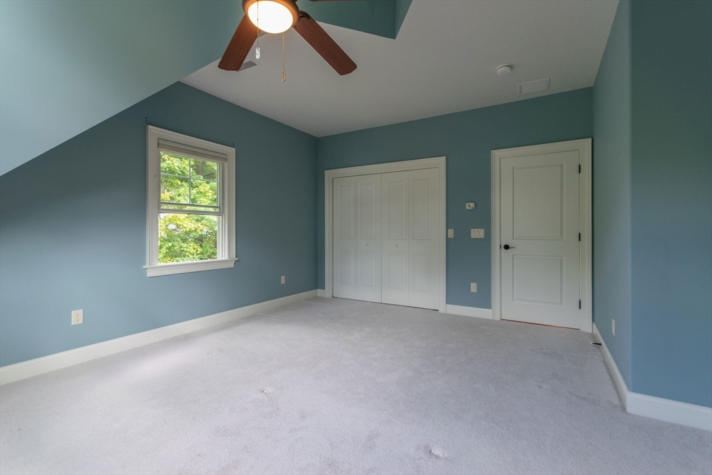 7 Western View Road Holyoke, MA 01040 - Photo 35 of 42 an empty room with windows and chandelier fan