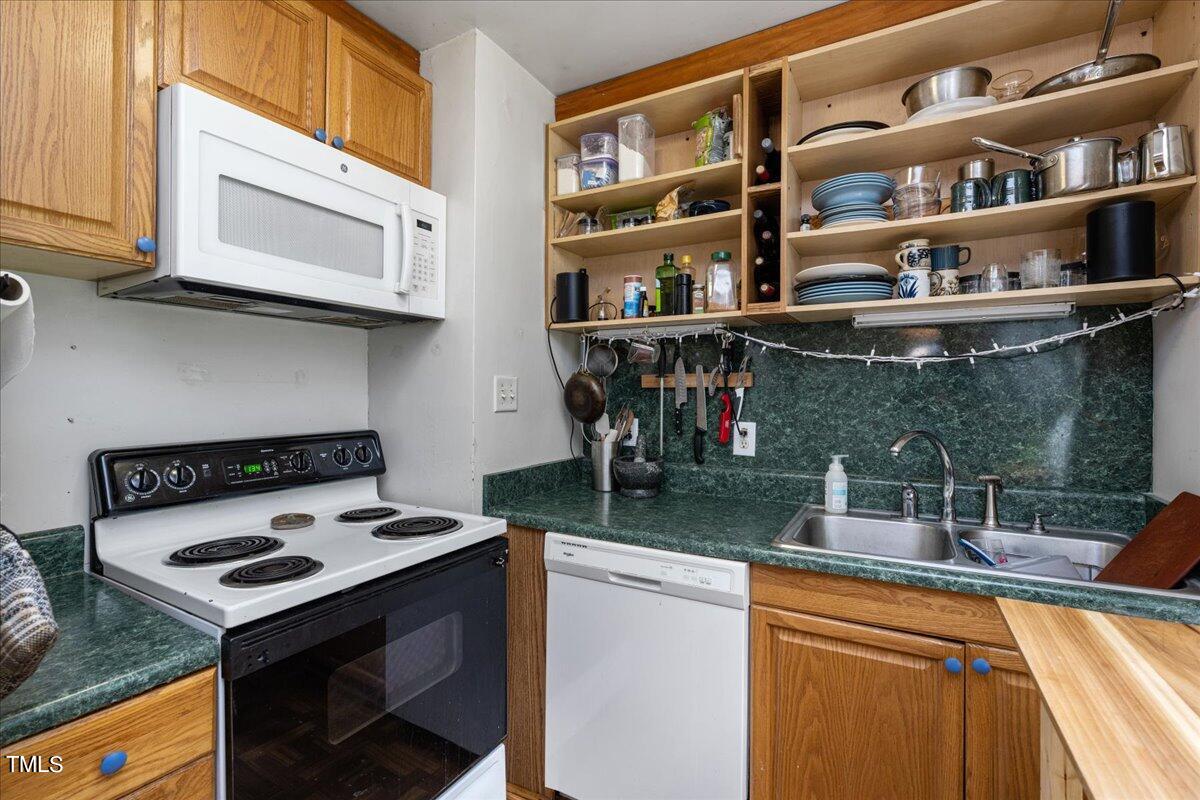 816 North King Charles Road Raleigh, NC 27610 - Photo 14 of 25 a kitchen with a stove and a microwave