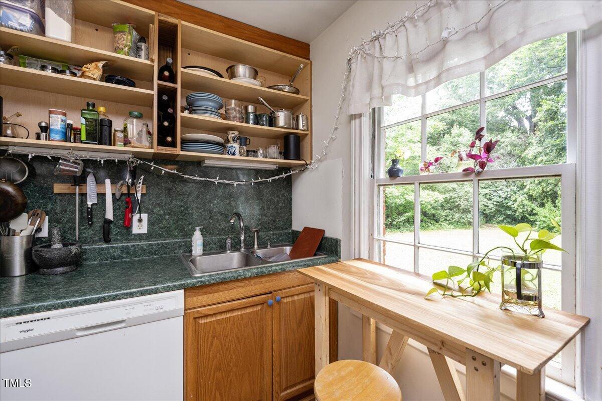 816 North King Charles Road Raleigh, NC 27610 - Photo 15 of 25 a kitchen with stainless steel appliances a sink and a large window