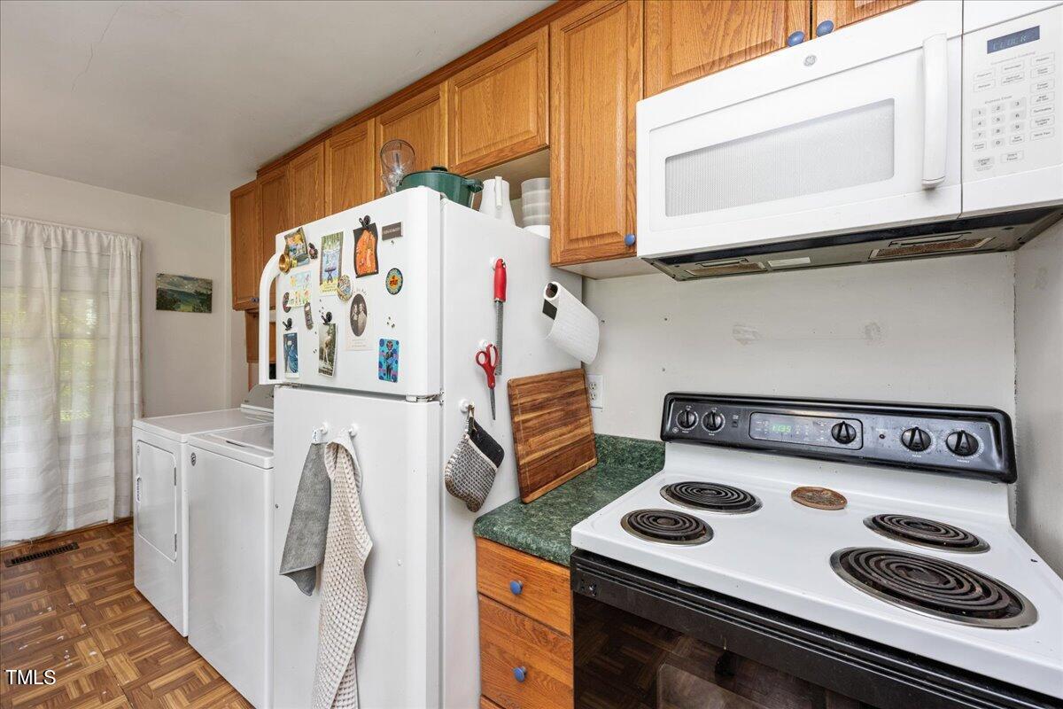 816 North King Charles Road Raleigh, NC 27610 - Photo 16 of 25 a kitchen with a stove and a white refrigerator