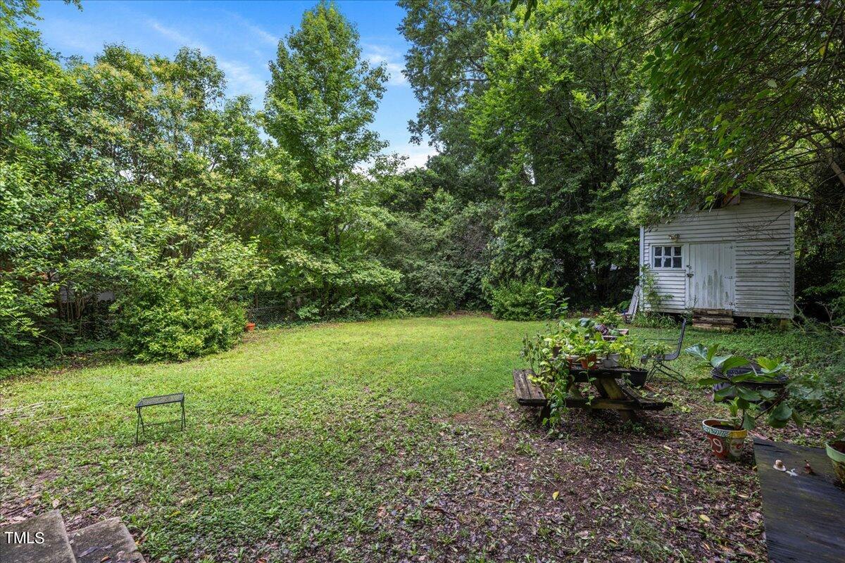 816 North King Charles Road Raleigh, NC 27610 - Photo 19 of 25 a backyard of a house with lots of green space