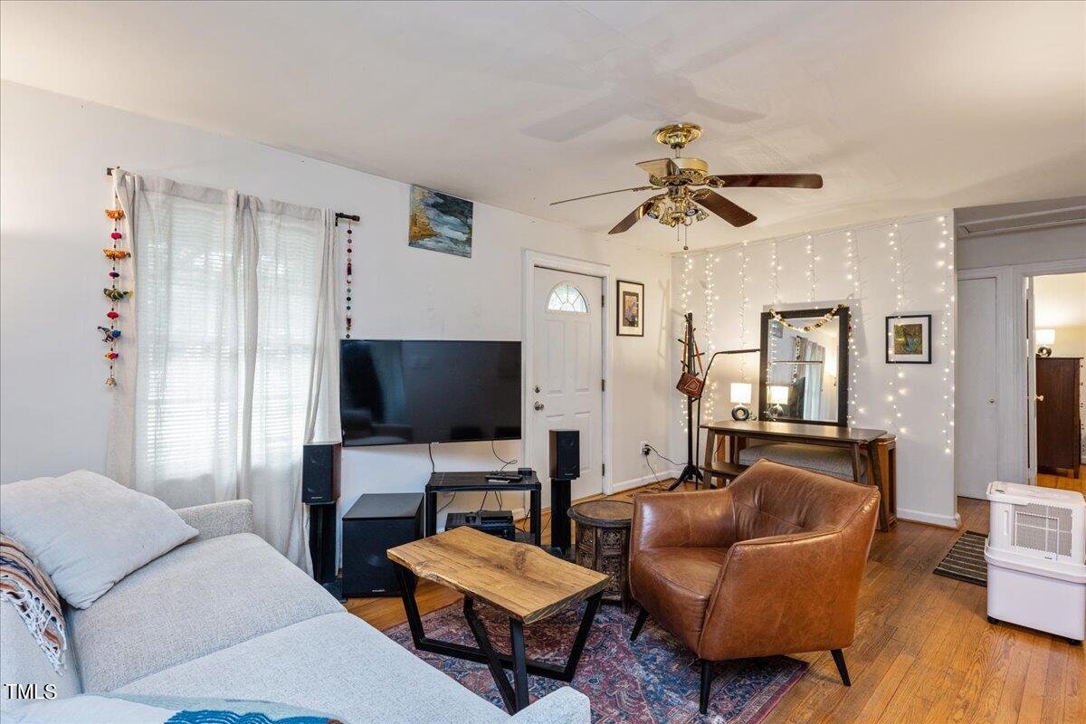 816 North King Charles Road Raleigh, NC 27610 - Photo 2 of 25 a living room with furniture and a flat screen tv