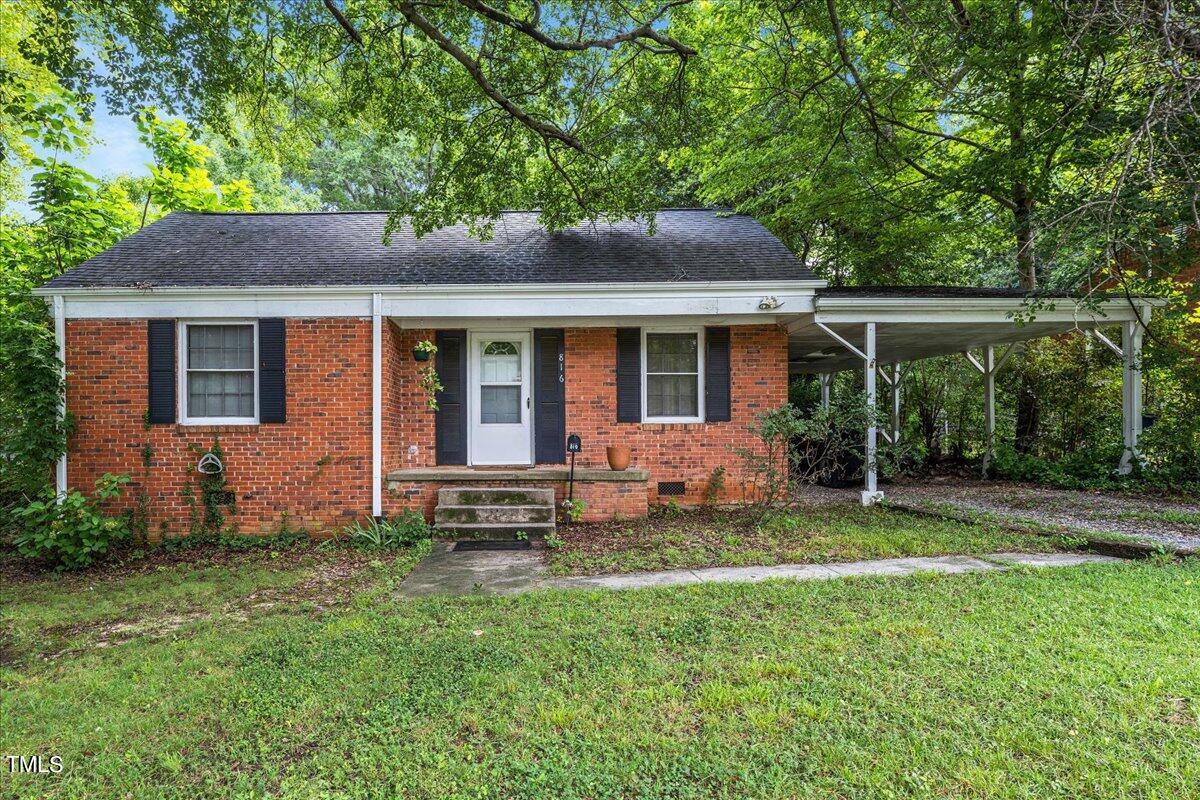 816 North King Charles Road Raleigh, NC 27610 - Photo 24 of 25 a front view of a house with a yard table and chairs