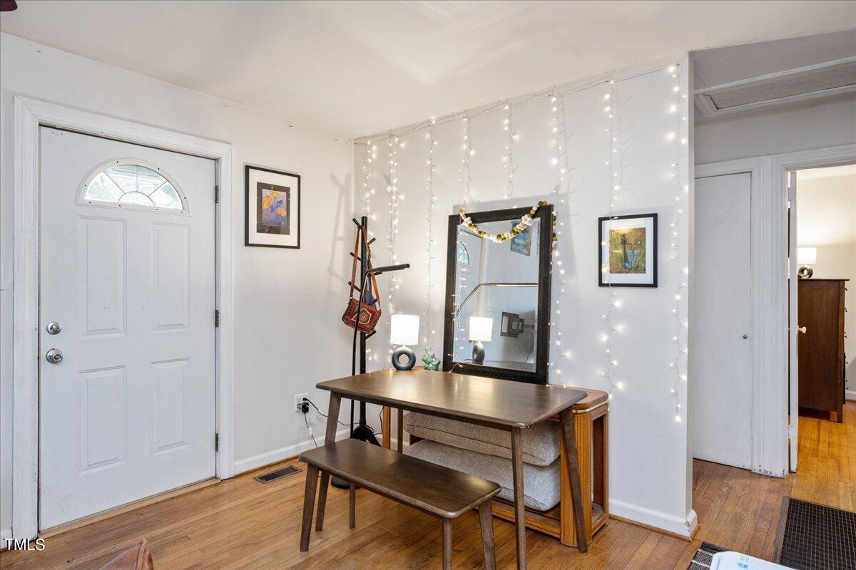 816 North King Charles Road Raleigh, NC 27610 - Photo 4 of 25 a workspace with furniture and wooden floor