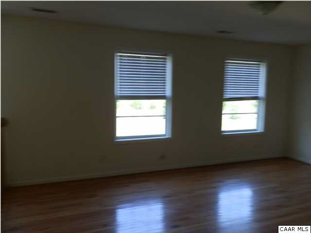 1744 Hanback Road Gordonsville, VA 22942 - Photo 11 of 21 an empty room with wooden floor and windows