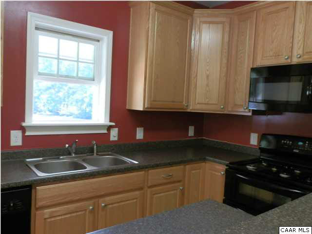 1744 Hanback Road Gordonsville, VA 22942 - Photo 3 of 21 a kitchen with granite countertop a sink stove and cabinets
