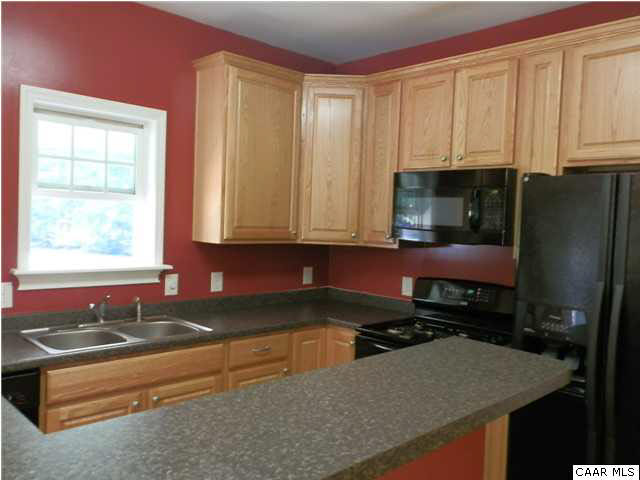 1744 Hanback Road Gordonsville, VA 22942 - Photo 4 of 21 a kitchen with stainless steel appliances granite countertop a sink stove and refrigerator