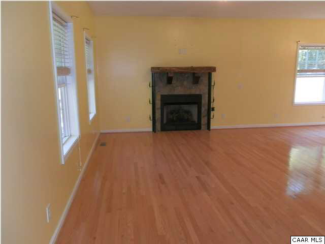 1744 Hanback Road Gordonsville, VA 22942 - Photo 8 of 21 a view of empty room with wooden floor and fireplace