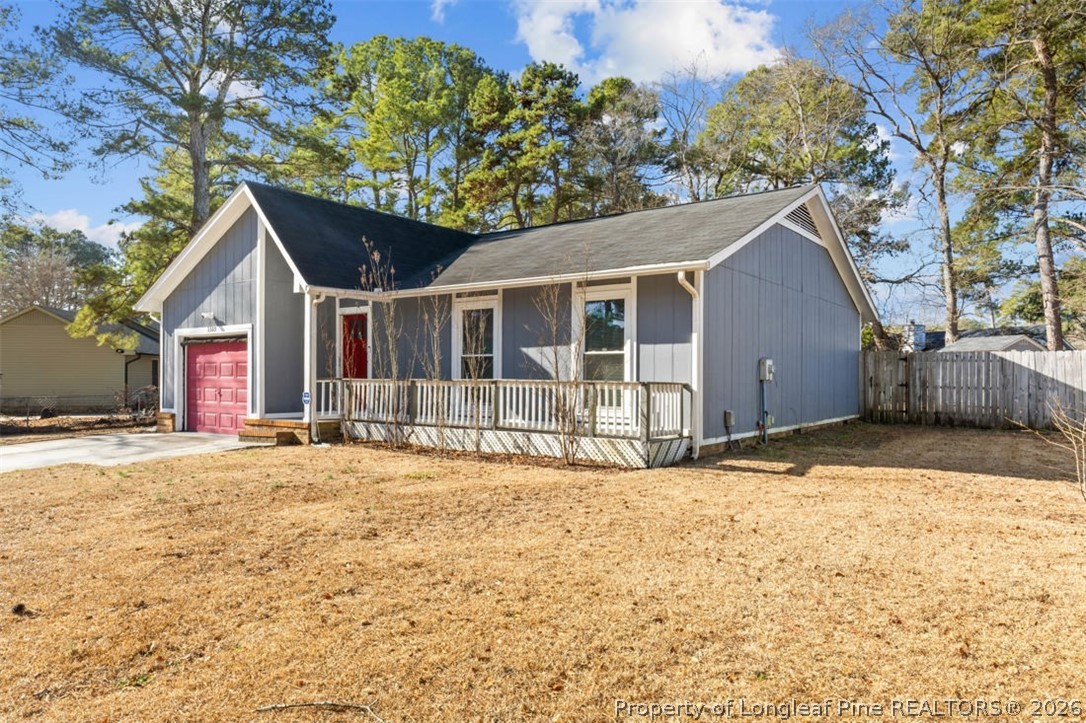 3305 Hunting Bay Drive Spring Lake, NC 28390 - Photo 4 of 27 a front view of a house with a yard and garage