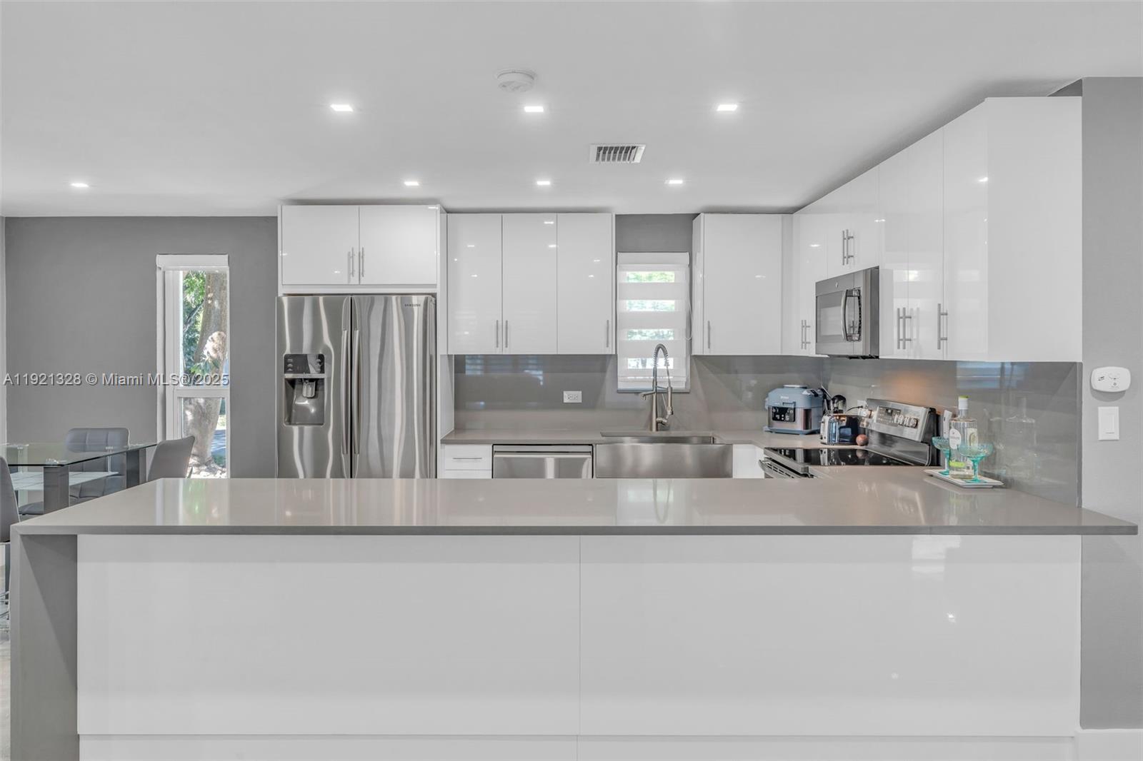 222 2nd Road Key Largo, FL 33037 - Photo 13 of 43 a large kitchen with stainless steel appliances granite countertop a refrigerator a sink and a stove